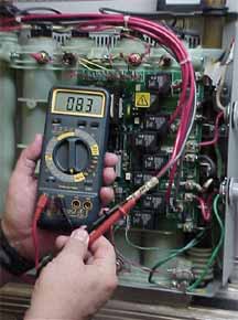 service person measuring voltage on a seisco unit