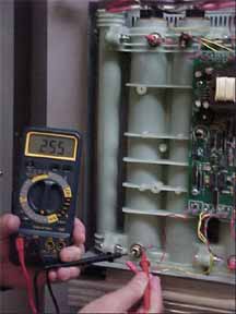 service person measuring voltage on a seisco unit