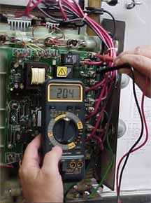 service person checking voltage on a Seisco unit